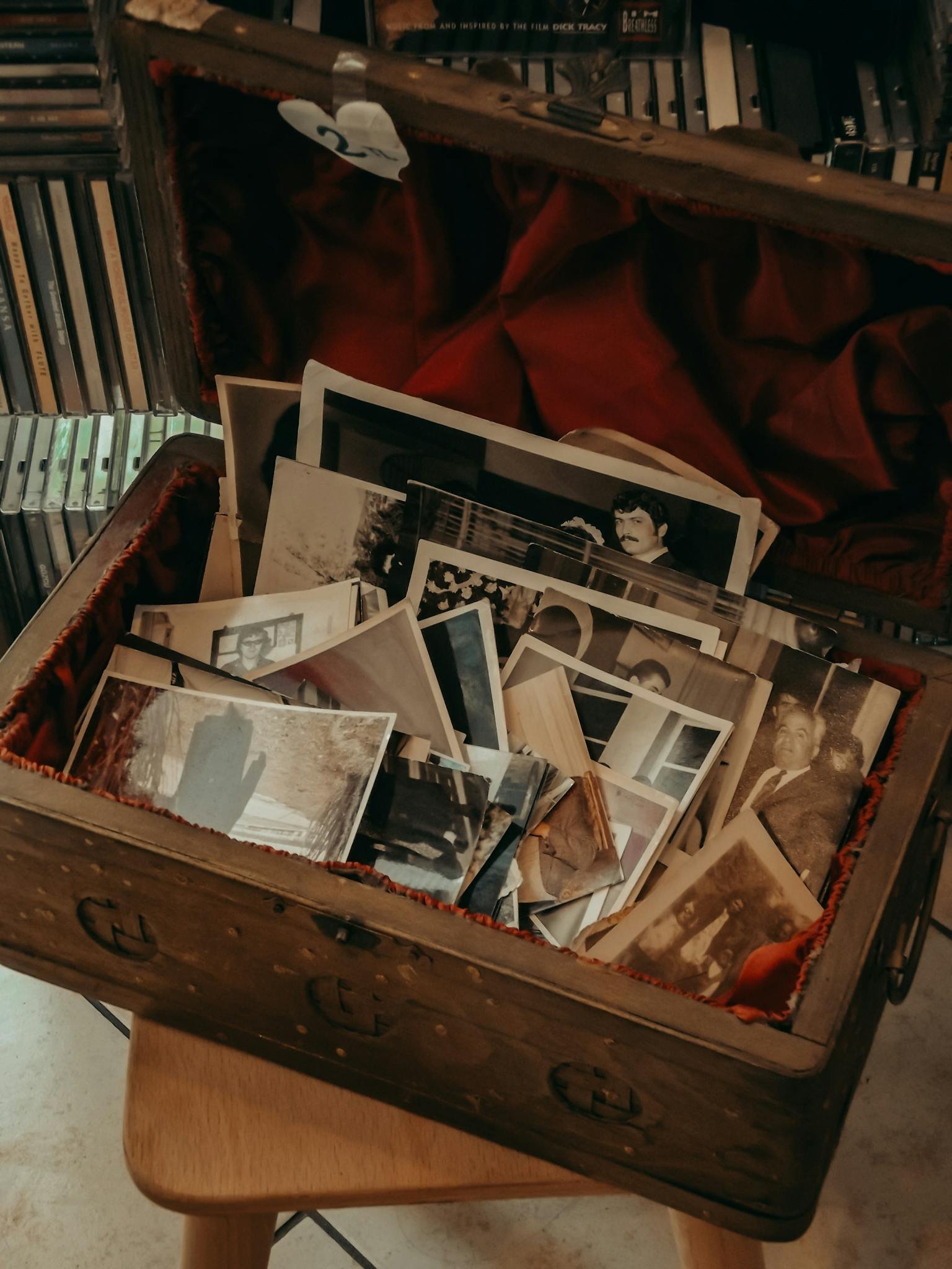 An open suitcase filled with vintage photographs, conveying nostalgia and memories.